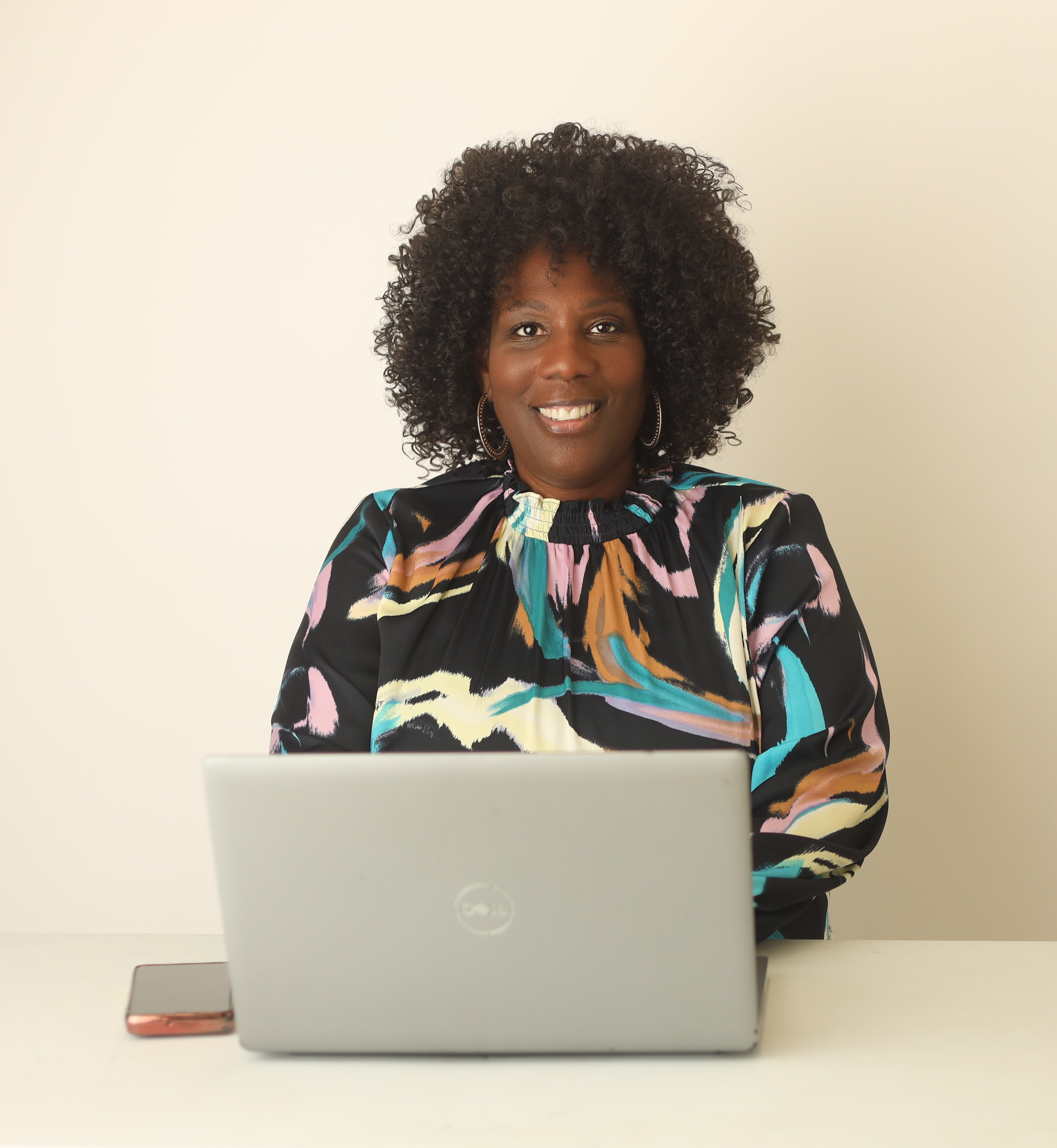 Monica L. Cook, The Paralegal Realtor, sitting with a laptop